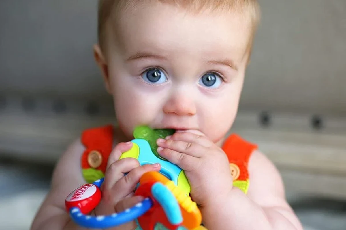 One year old baby playing safely with age-appropriate toys in a home setting